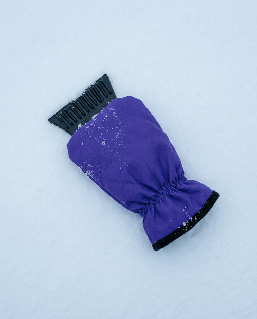Coldstart ice scraper glove on snow showing the grooved blade