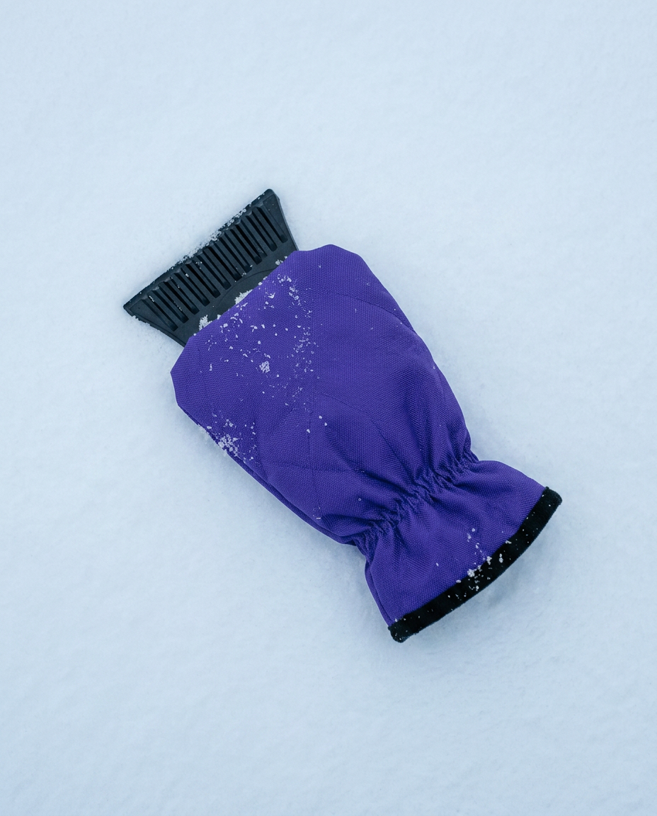 Coldstart ice scraper glove on snow showing the grooved blade