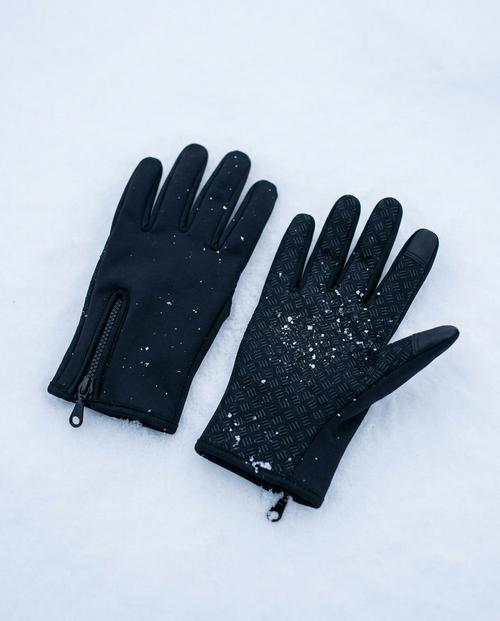 Coldstart touchscreen driving gloves on snow, palm and back shown